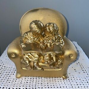 Golden decor of toddlers reading book / bookend